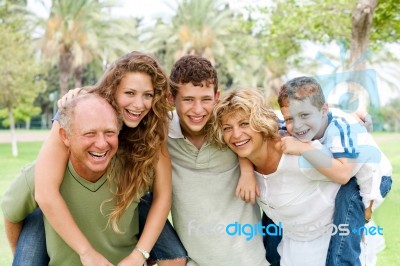 Young Generation Enjoying Piggyride Stock Photo