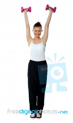 Young Girl Exercising With Dumbbells Stock Photo