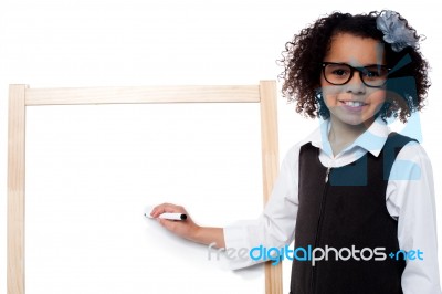 Young Girl Holding Black Marker Pen, Ready To Write Stock Photo
