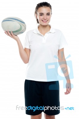Young Girl Holding Rugby Ball Stock Photo