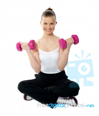 Young Girl Lifting Weights Stock Photo