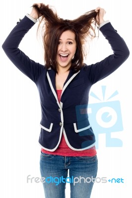 Young Girl Pulling Her Hair In Excitement Stock Photo