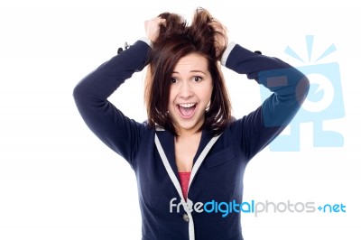 Young Girl Pulling Her Hair In Excitement Stock Photo