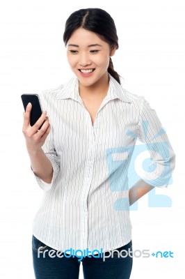 Young Girl Reading Text Messages Stock Photo