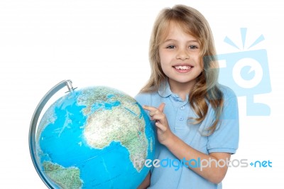 Young Girl Selecting Holiday Destination Over Globe Stock Photo