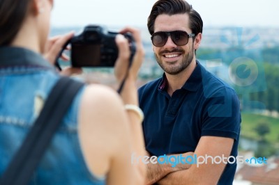 Young Girl Taking Photo Of His Boyfriend Stock Photo
