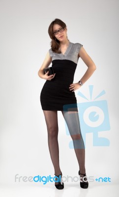 Young Girl With Glasses And A Black Dress Stock Photo