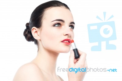 Young Gorgeous Woman Applying Lipstick Stock Photo
