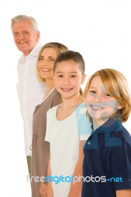 Young Grandmother And Grandfather With Nephew And Niece Standing… Stock Photo
