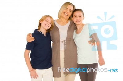 Young Grandmother With Nephew And Niece Standing On White Backgr… Stock Photo