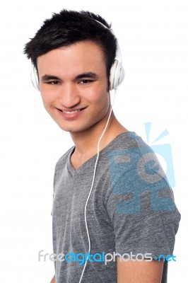 Young Guy Enjoying Music Stock Photo