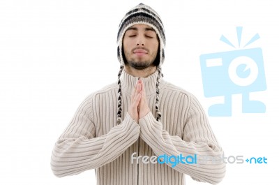 Young Guy Praying With Woolly Hat Stock Photo