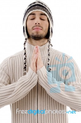 Young Guy Praying With woolly hat Stock Photo