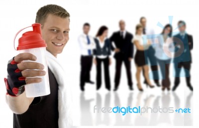 Young Guy Showing Sipper Bottle And His Team Standing On His Back Stock Photo