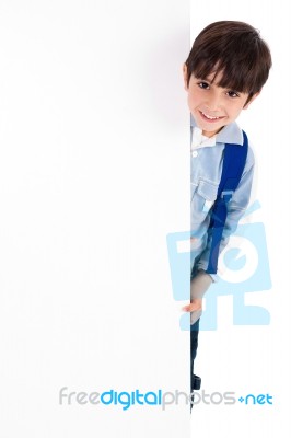 Young Kid Silently Standing Behind The Board Stock Photo