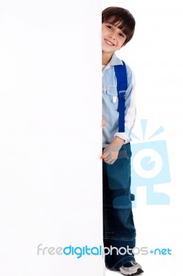 Young Kid Standing Behind The Board Stock Photo