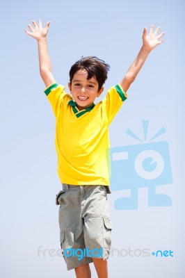 Young Kid With Raised Arms Stock Photo