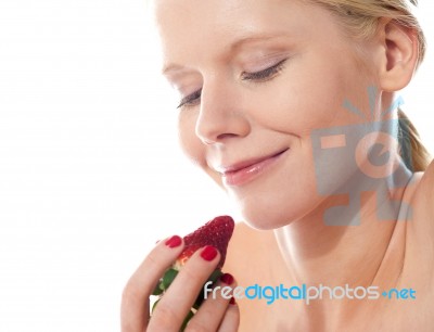 Young Lady Holding A Strawberry Stock Photo