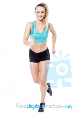 Young Lady Running In Sportswear Stock Photo