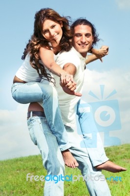 Young Male Carrying Woman Stock Photo