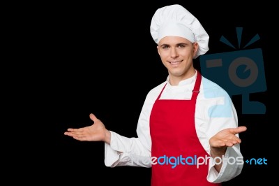 Young Male Chef Welcoming His Guests Stock Photo