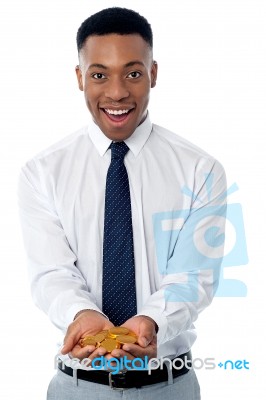 Young Male Executive Holding Gold Coins Stock Photo