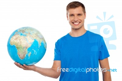 Young Male Holding Globe Stock Photo