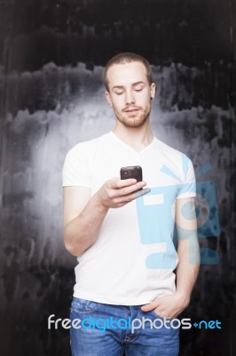 Young Male Reading Sms Stock Photo