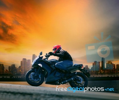 Young Man And Safety Suit Riding Big Motorcycle Against Beautifu… Stock Photo