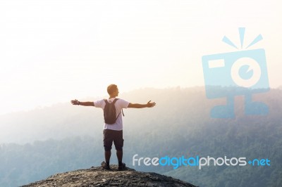 Young Man  Asia Tourist  At Mountain Is Watching Over The Misty Stock Photo