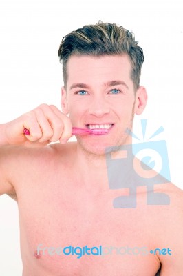 Young Man Brushing His Teeth Stock Photo