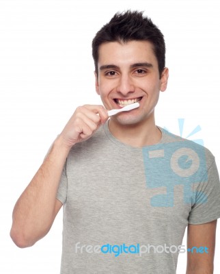 Young Man Brushing Teeth Stock Photo