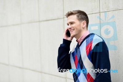 Young Man Busy In A Phone Conversation Stock Photo