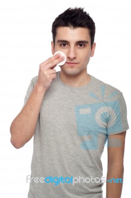 Young Man Cleaning Face Stock Photo