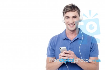 Young Man Enjoying Music From His Cell Phone Stock Photo