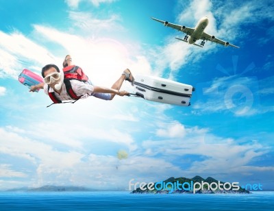 Young Man Flying On Blue Sky Wearing Snorkeling Mask And Holding… Stock Photo