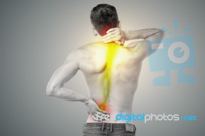 Young Man Has Pain In His Back Stock Photo