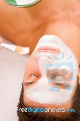 Young Man Having Facial Spa Treatment Stock Photo