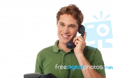 Young  Man Holding A Receiver And Talking Stock Photo