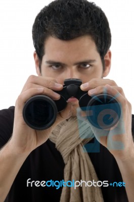 Young Man Holding Binocular Stock Photo