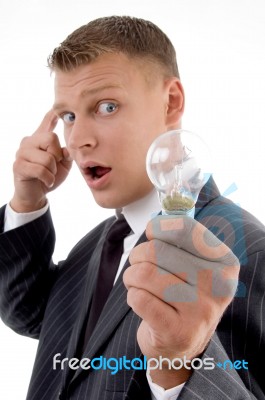 Young Man Holding Electric Bulb Stock Photo