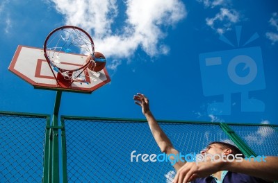 Young Man Playing Basketball Stock Photo