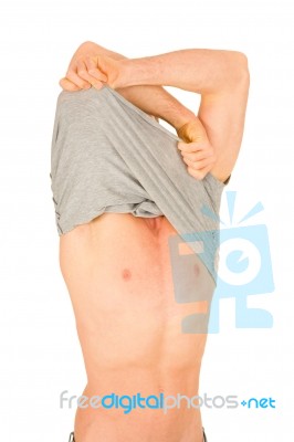 Young Man Removing T Shirt Stock Photo