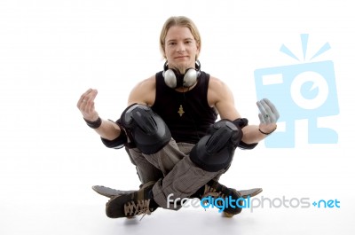 Young Man Sitting On Skateboard Stock Photo