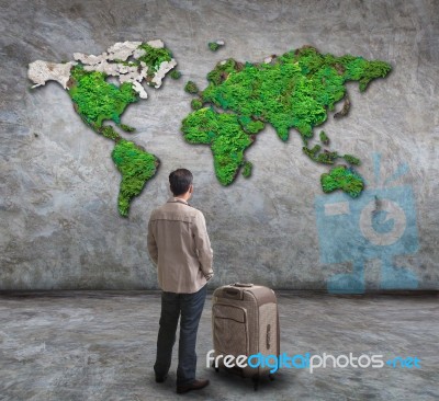 Young Man Standing And Looking To World Map On Wall Stock Photo Young Man Standing And Looking To World Map On Wall Stock Photo