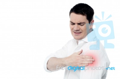 Young Man Suffering From Shoulder Pain Stock Photo