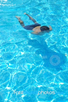 Young Man Swimming Underwater Stock Photo