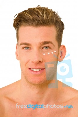 Young Man With Anti Wrinkle Cream Stock Photo