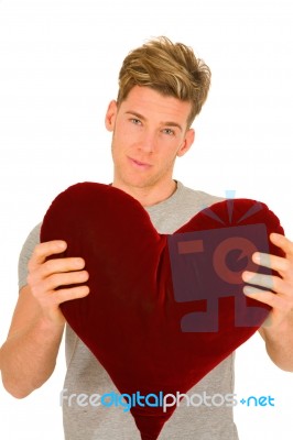 Young Man With Heart Shaped Pillow Stock Photo