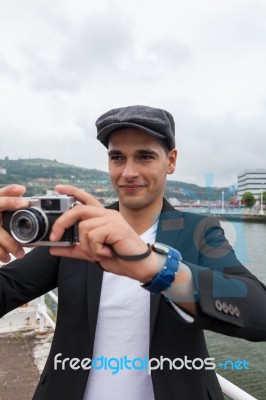 Young Man With Irish Beret Taking A Photo Stock Photo Young Man With Irish Beret Taking A Photo Stock Photo